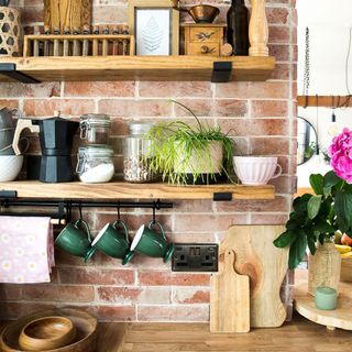 kitchen with brick wall and wooden shelves