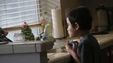 A child stares out of a window