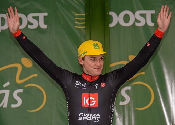 Peter Hawkins (IG Sigma Sport) steps to the podium to collect his An Post Ras race leader's jersey