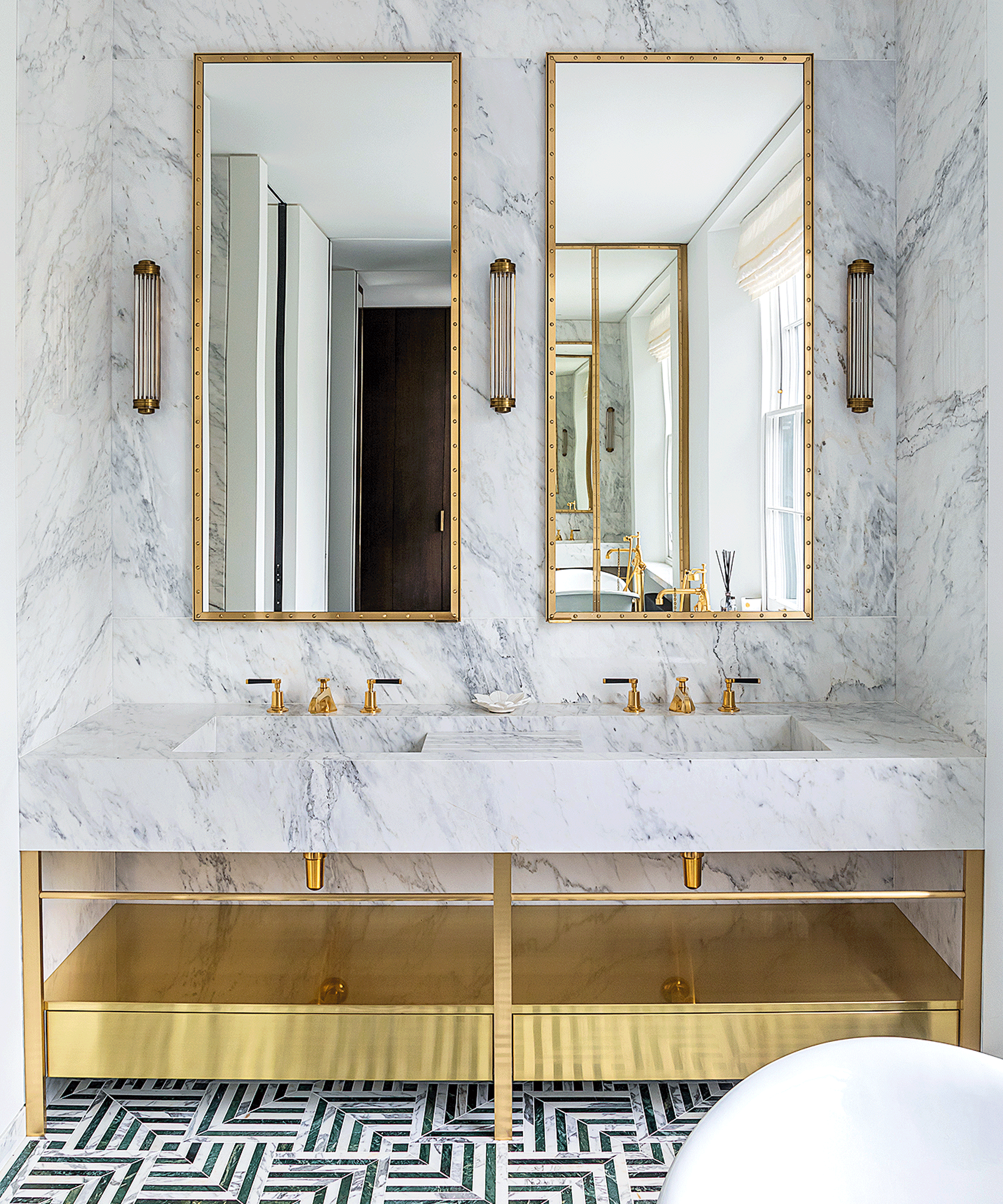 marble double sink in bathroom with gold accents