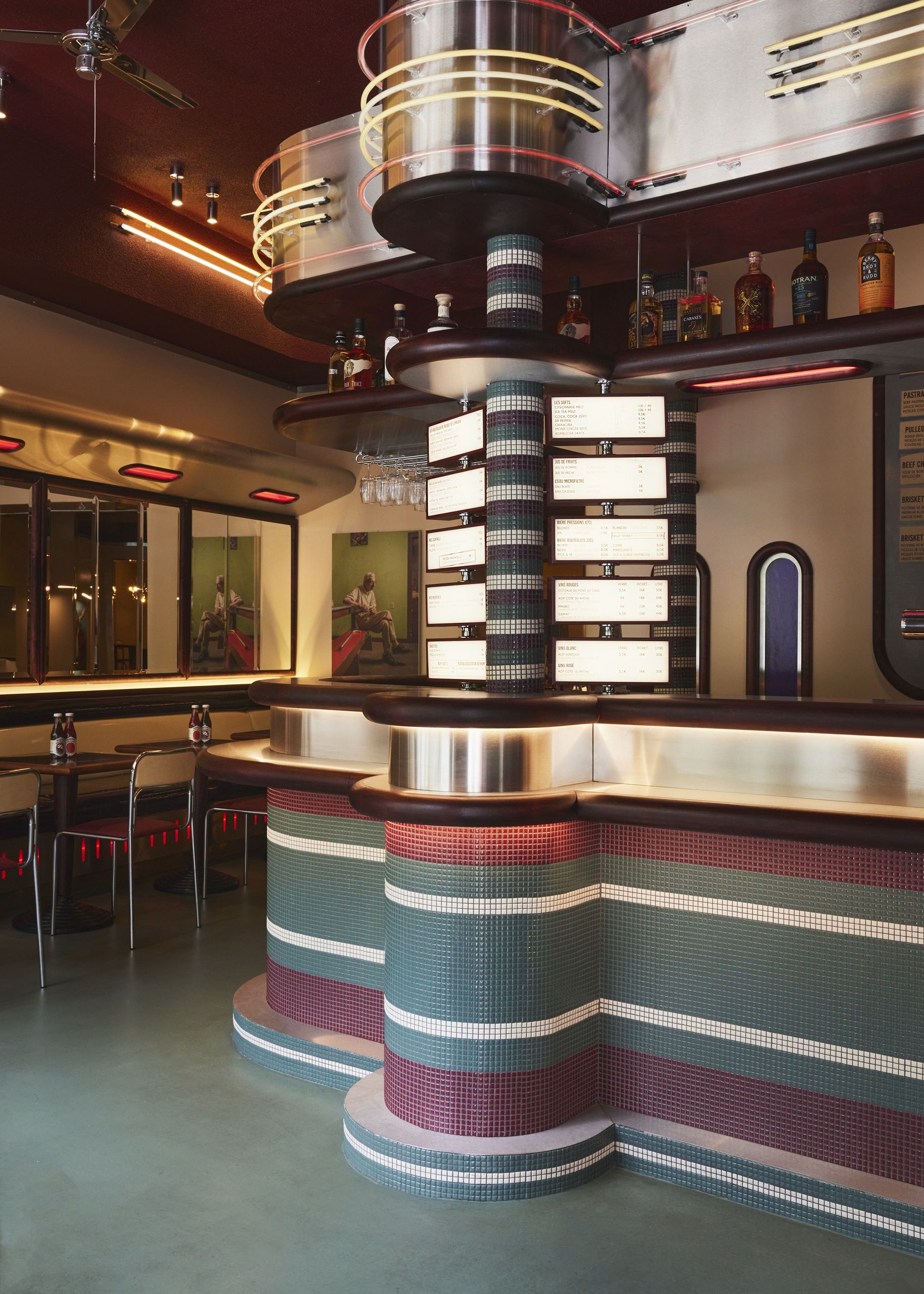 the interiors of a diner in paris with blue and red color palettes and retro style