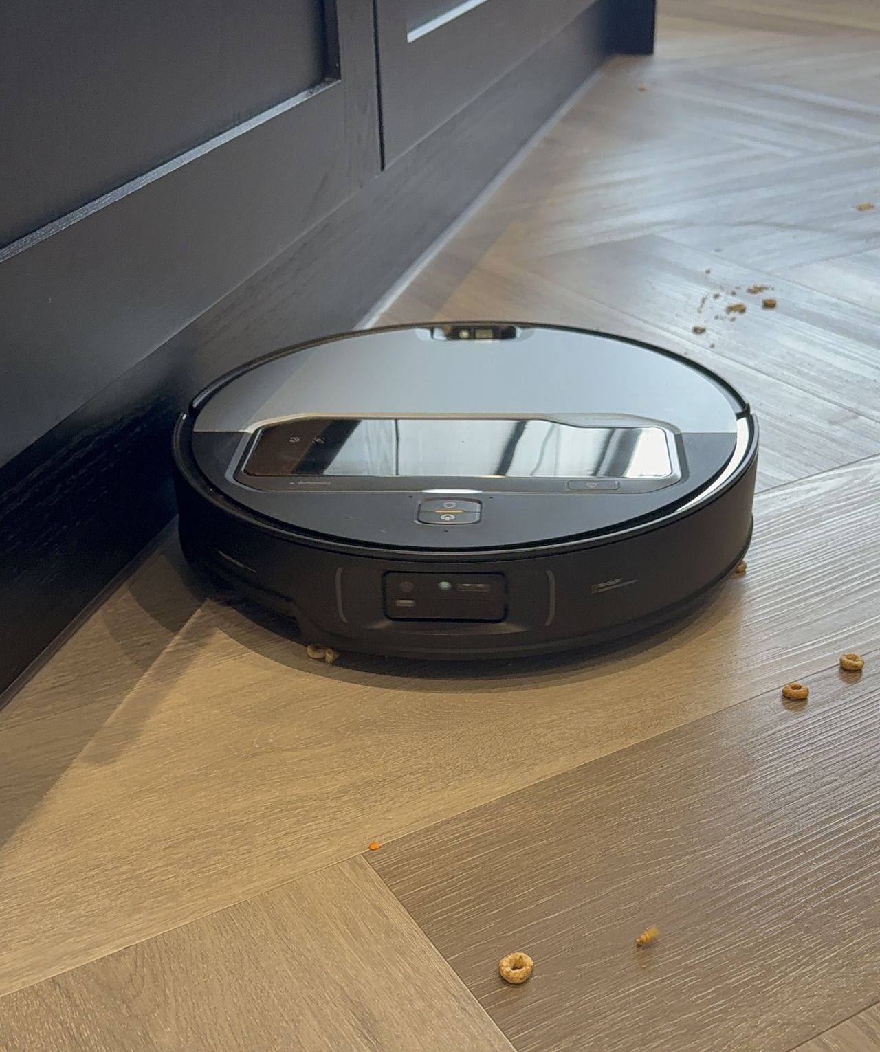 Roborock Saros Z70 on hard floor pictured next to cereal and dark gray cabinets in Victoria Woollaston's home