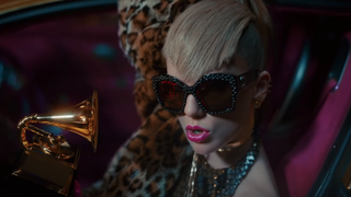 Taylor Swift in sunglasses, holding a Grammy in Look What You Made Me Do music video