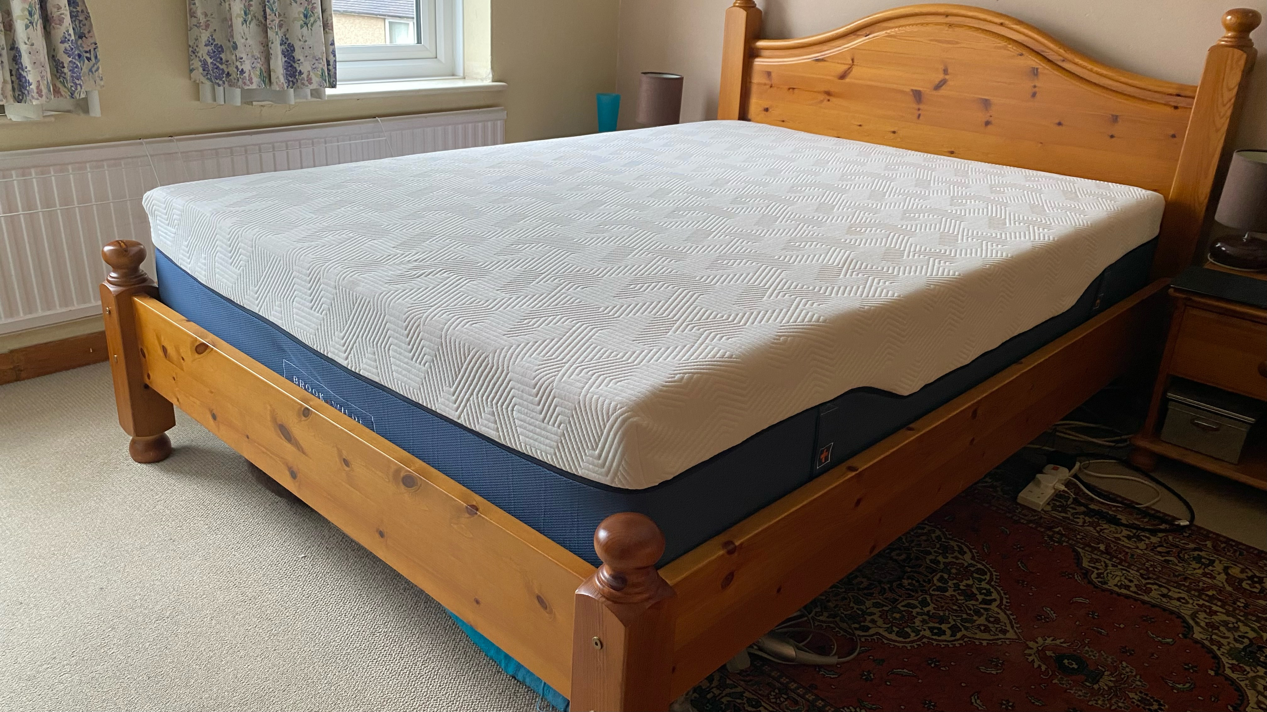 Brook + Wilde Suprema Mattress review image shows the mattress on our lead tester's wooden bed