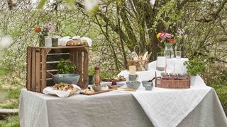 garden party idea for dressing tabel with wooden platters and crates to create a grazing table