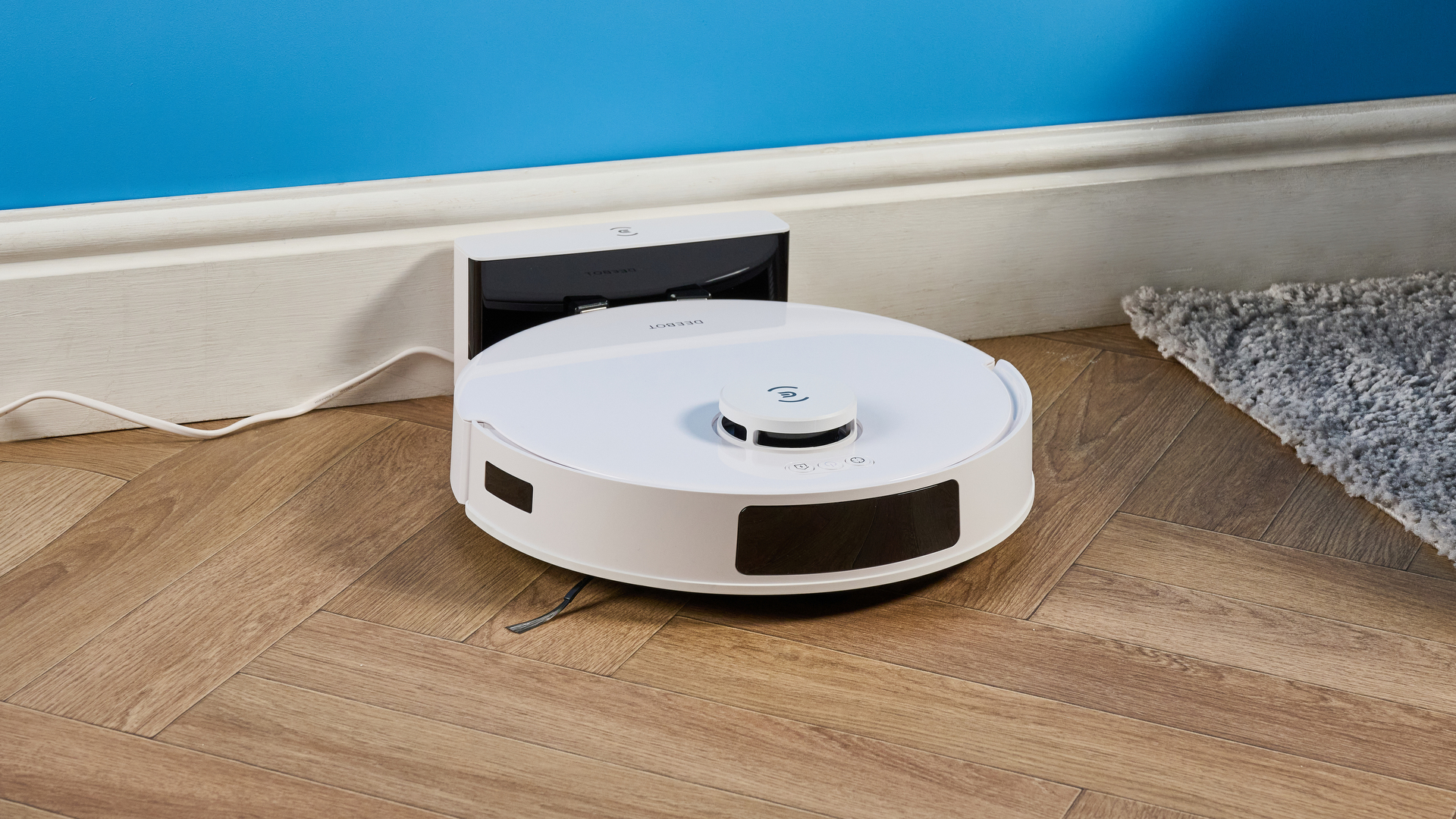 Ecovacs Deebot N20 in white photographed vacuuming floor