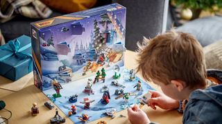 Lego Star Wars Advent Calendar being played with by a child, viewed from over their shoulder.