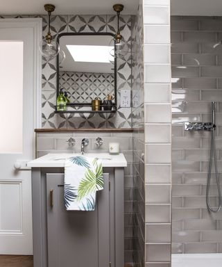 bathroom with white basin top and grey cabinet