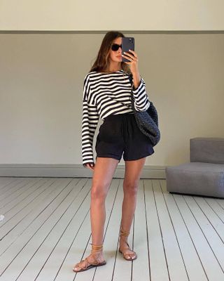 Influencer styles fisherman sandals with short and a long sleeve t-shirt.