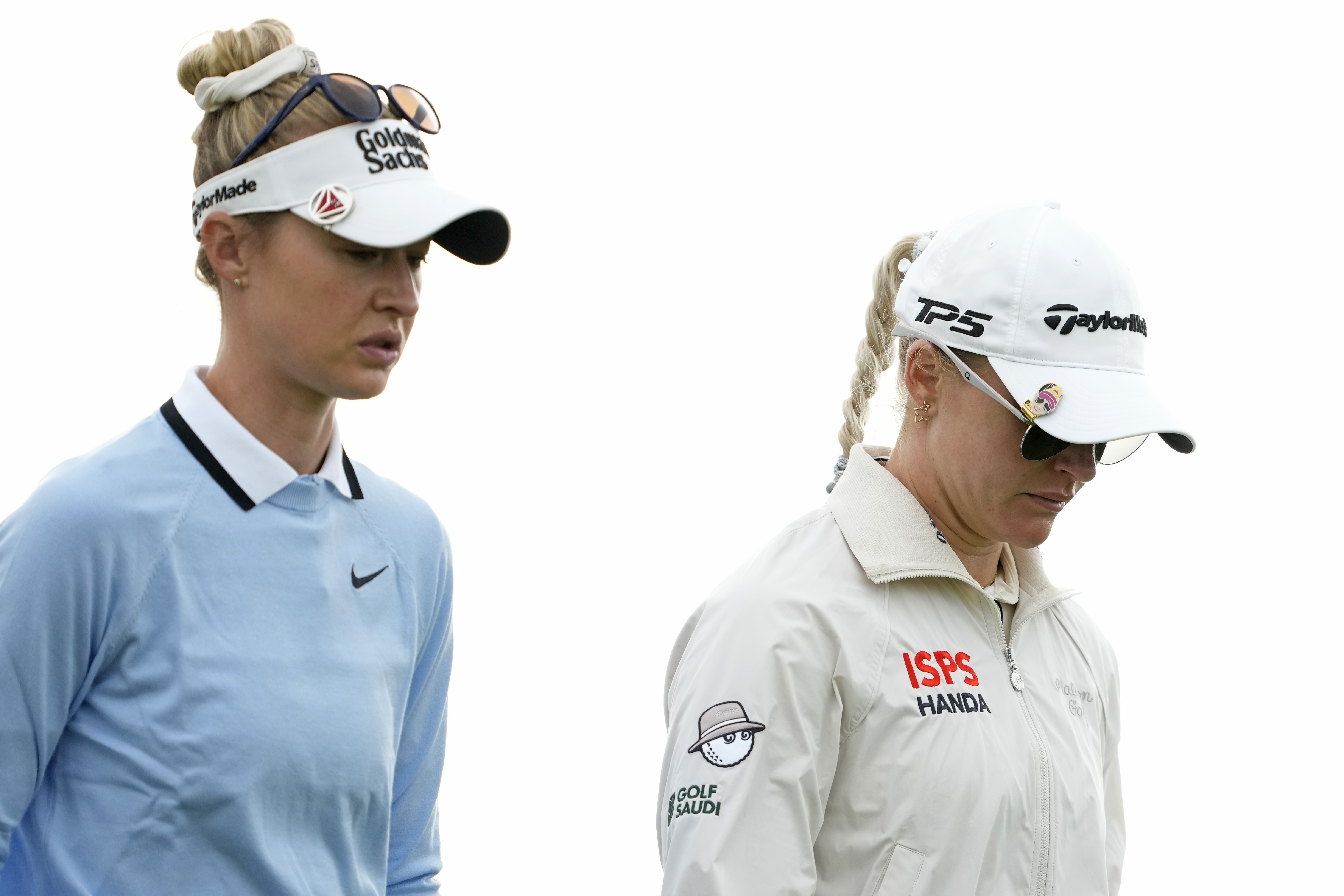 Nelly Korda and Charley Hull walk off the putting green