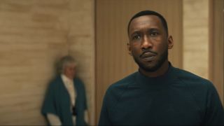 Mahershala Ali looks upset with Glenn Close in the background in Swan Song.