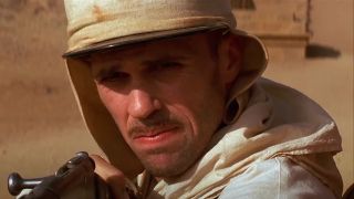 Kevin J O'Connor looks ahead in the desert with a face of concern in The Mummy.