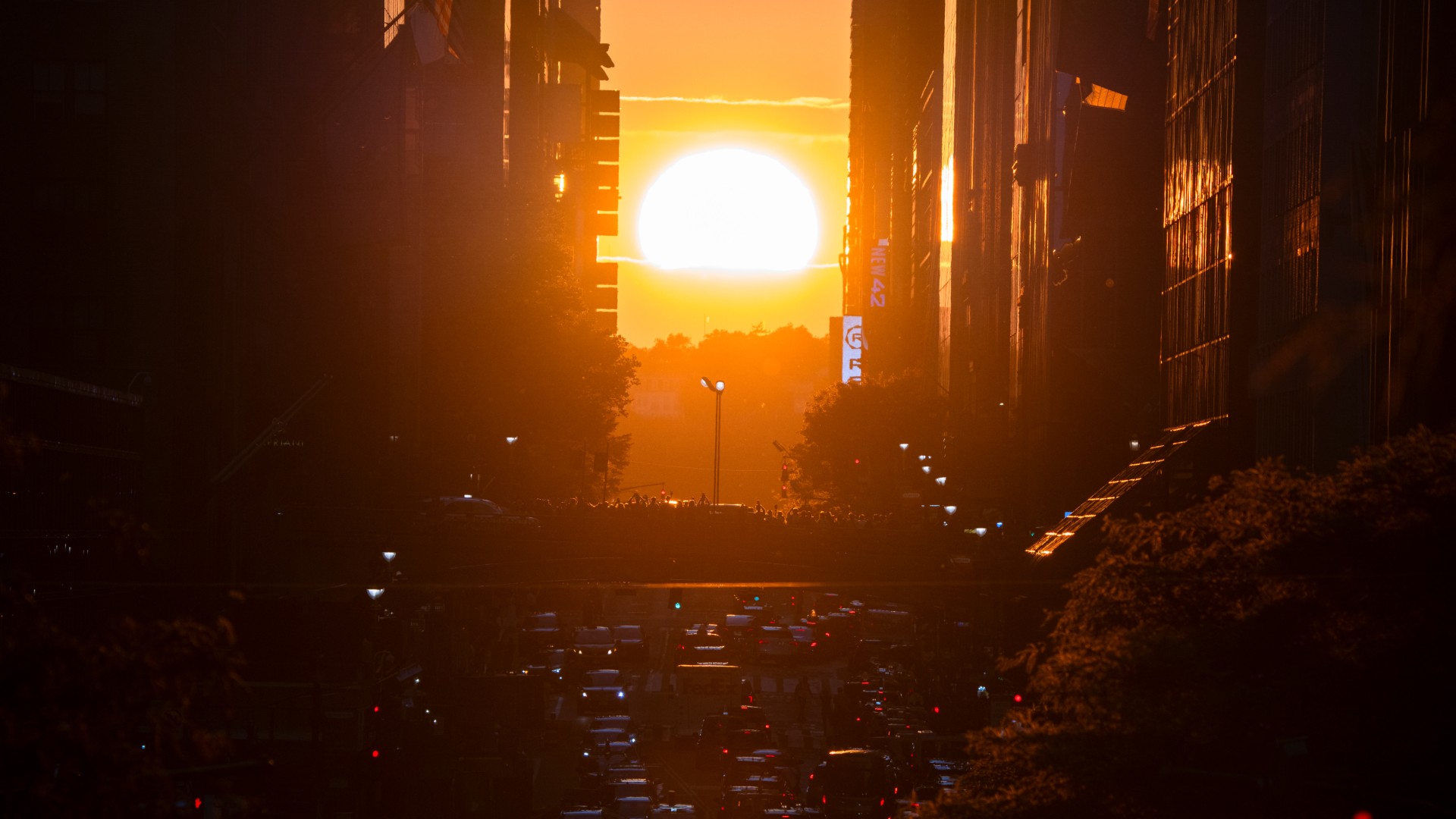 The sunset in Manhattan can be seen between skyscrapers