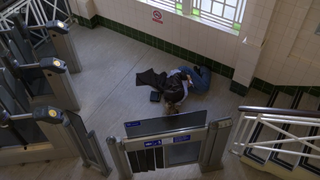 Janine Butcher curled up on the tube station floor after falling down the stairs
