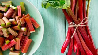 rhubarb being prepared for cooking on blue table