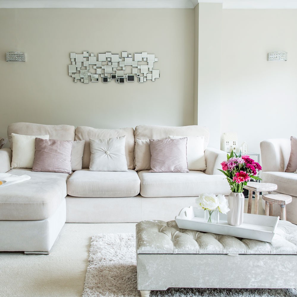 living room with white walls and white sofa.