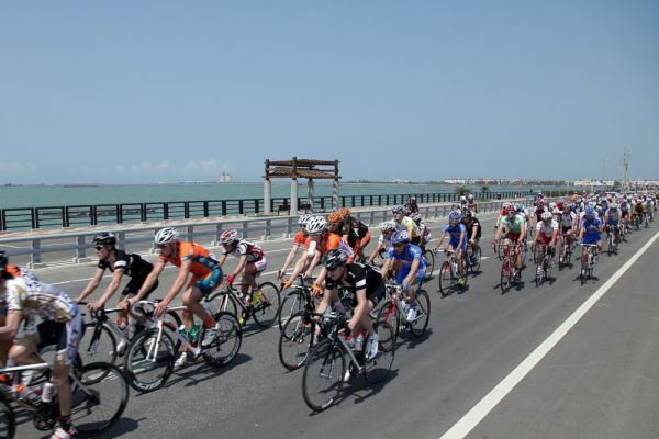 The peloton makes its way beneath blue skies
