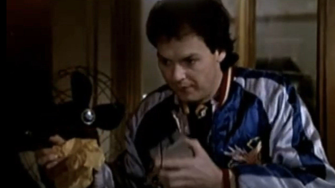 Michael Keaton as Bill Blazejowski speaking into his tape recorder in Night Shift