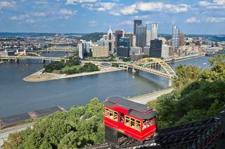 The red Duquesne Incline funicular with Pittsburgh in the background
