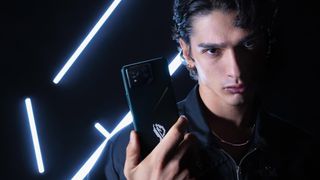 A model holding the Asus ROG Phone 8 Pro