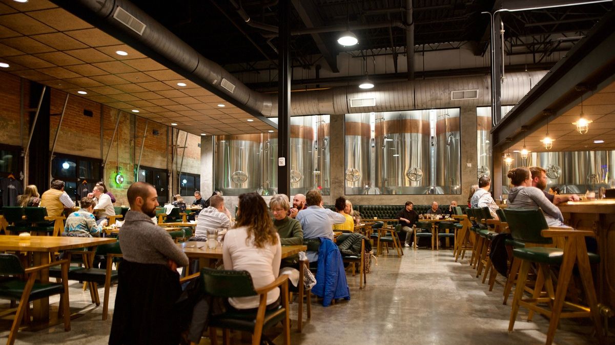 People sitting in the dining area of a Texas beer spa.