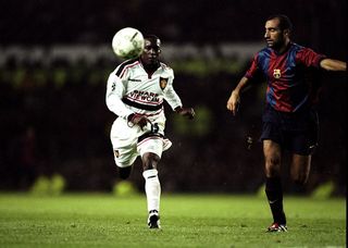 Dwight Yorke of Manchester United challenging Abelardo of Barcelona during the Champions League match at Old Trafford in Manchester, England. The game ended in a draw 3-3.