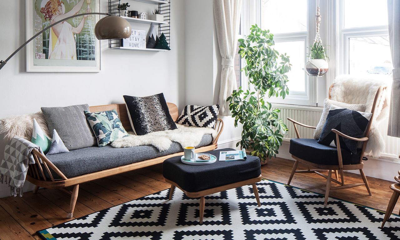 living area with white wall and wooden floor and sofa