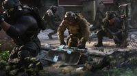 Surrounded by squadmates, a soldier kneels over a bag overflowing with cash.