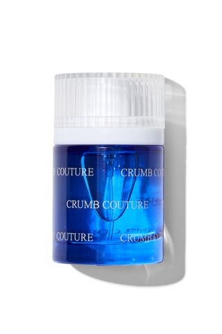 Snif Crumb Couture perfume in small blue bottle with textured white cap on white background with shadow 