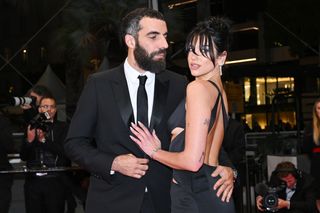 Dua Lipa and Romain Gavras attend the "Omar La Fraise (The King of Algiers)" red carpet during the 76th annual Cannes film festival at Palais des Festivals on May 19, 2023 in Cannes, France