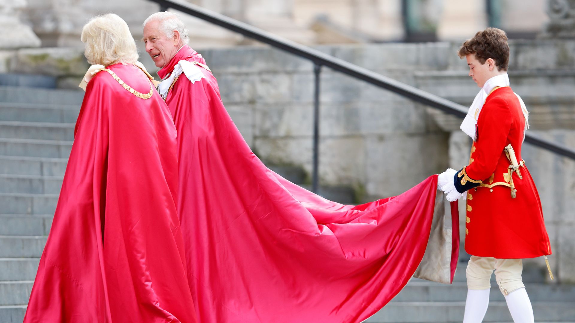 King Charles, Queen Camilla and a Page of Honour carrying his cape