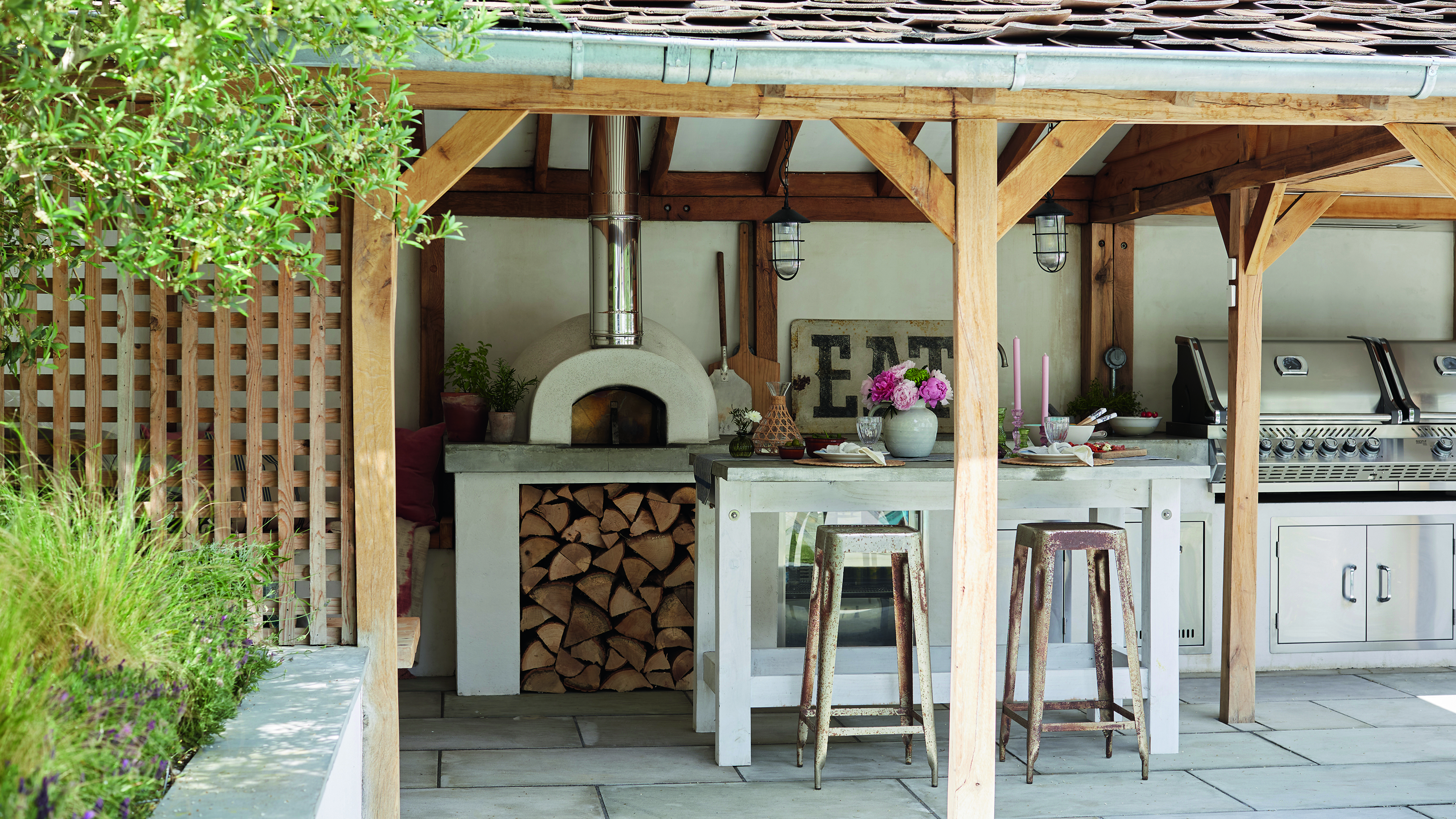 outdoor kitchen under pergola in garden