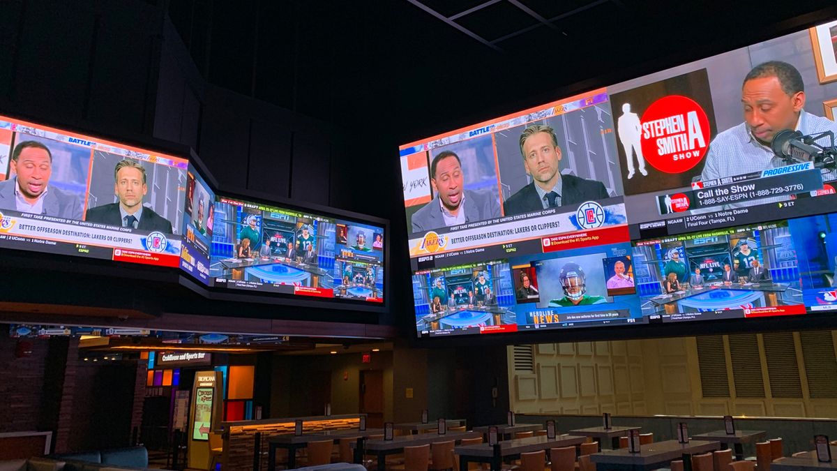 A large-scale video wall at the Tropicana Sportsbook featuring Unilumin displays and Premier Mounts.