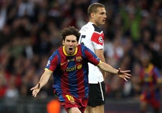 Lionel Messi runs away from Manchester United's Nemanja Vidic after scoring Barcelona's second in the 2011 Champions League final