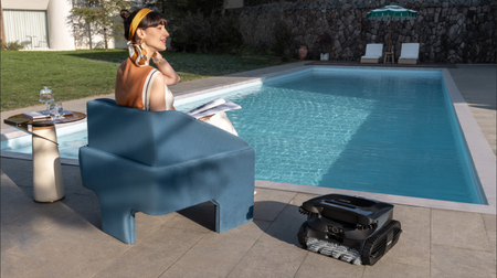 Woman sat next to pool with Beatbot machine