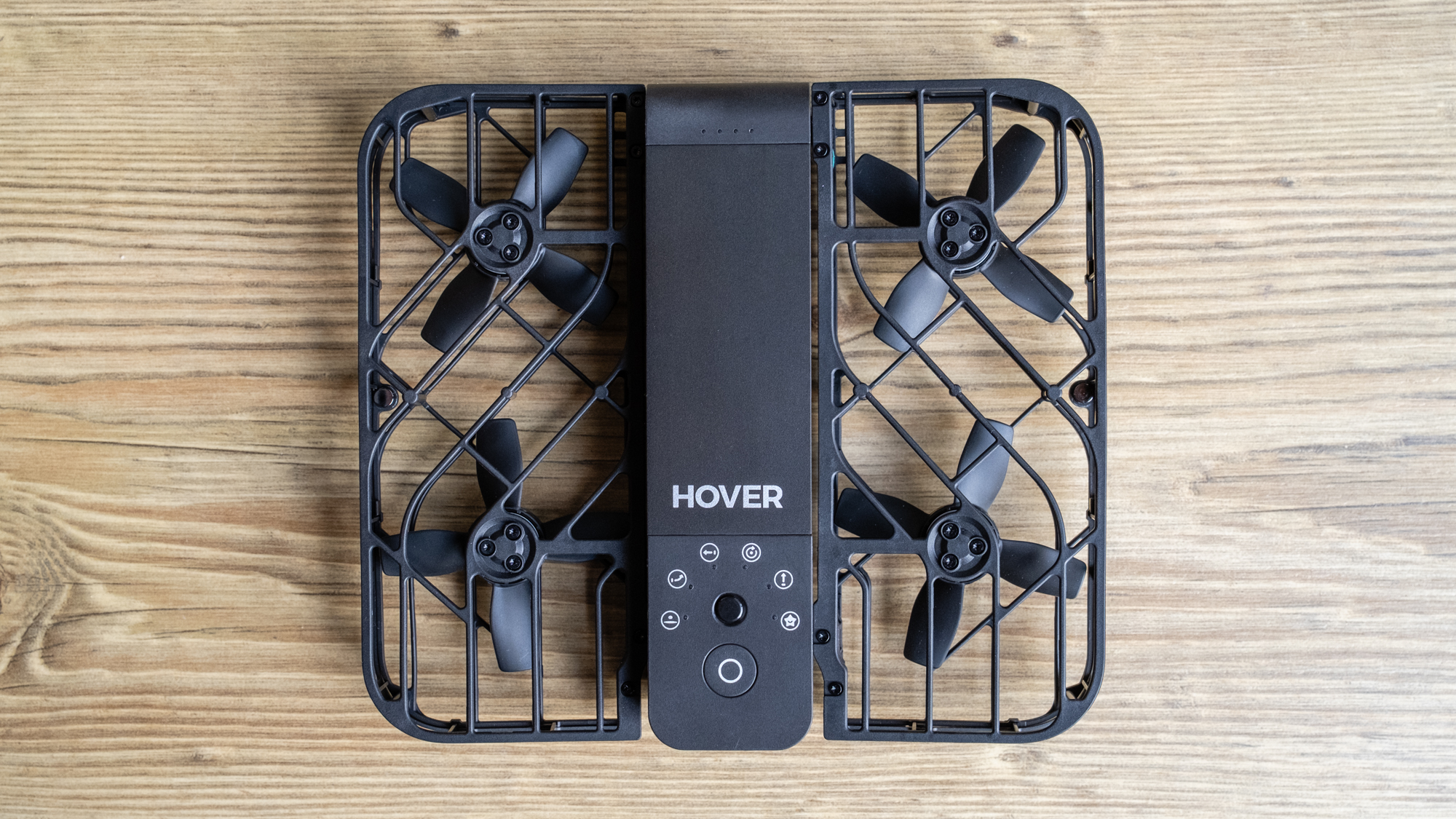 a miniature drone with a black grid caging its propellers.