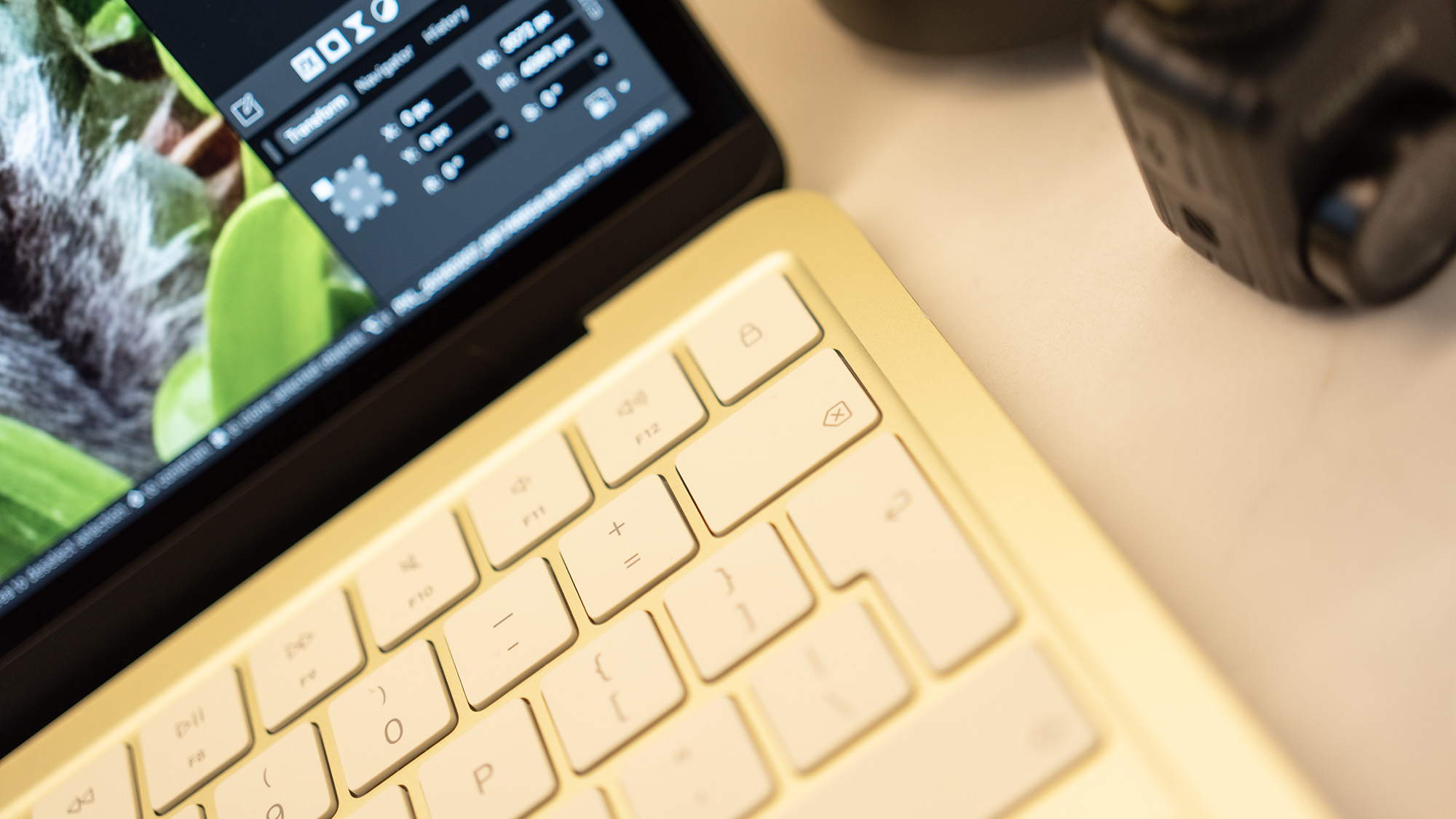 Apple MacBook Neo laptop in yellow on a desk