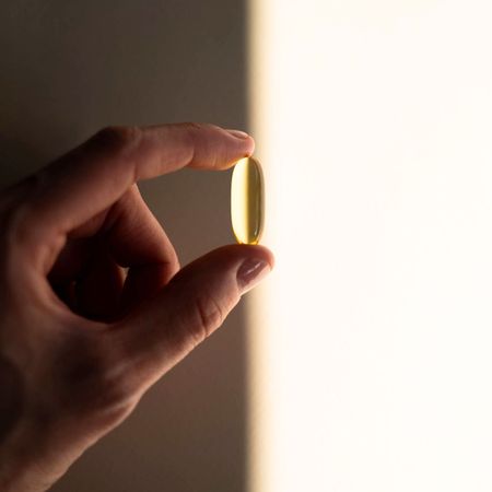 A woman body brushing, taking a supplement, and heading to a workout class in gym city