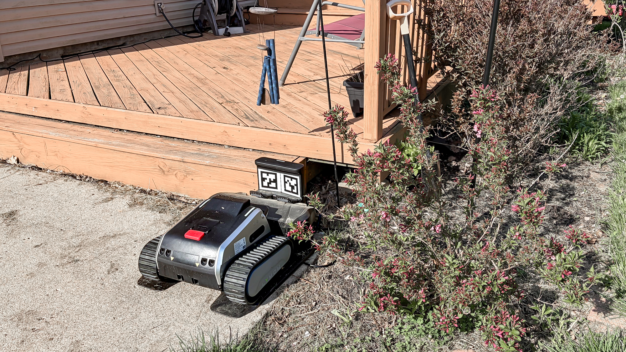 Lymow One Plus robot mower in charging dock