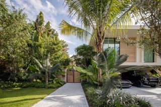 Sunset Island Residence by Strang Design exterior with lush garden