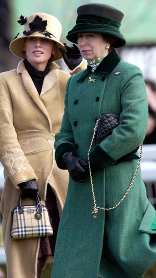 Princess Anne wearing her green coat, standing next to Zara Tindall at Cheltenham in 2002