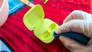 Cleaning the interior of a sports earbud charging case