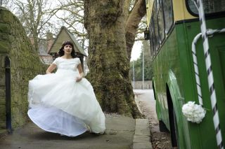 Fenisha runs for the bus in her wedding dress