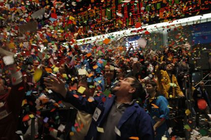 CHICAGO - DECEMBER 31:Traders and clerks in the Eurodollar trading pit at the CME Group's Chicago Board of Trade celebrate as confetti falls signaling the end of the trading year December 31,