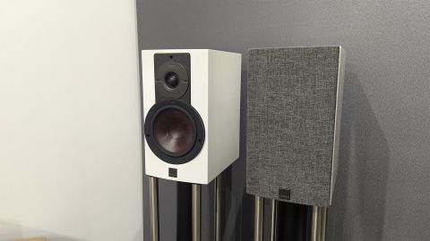 Dali Rubikore 2 standmount speakers one with grille on one without in corner of room