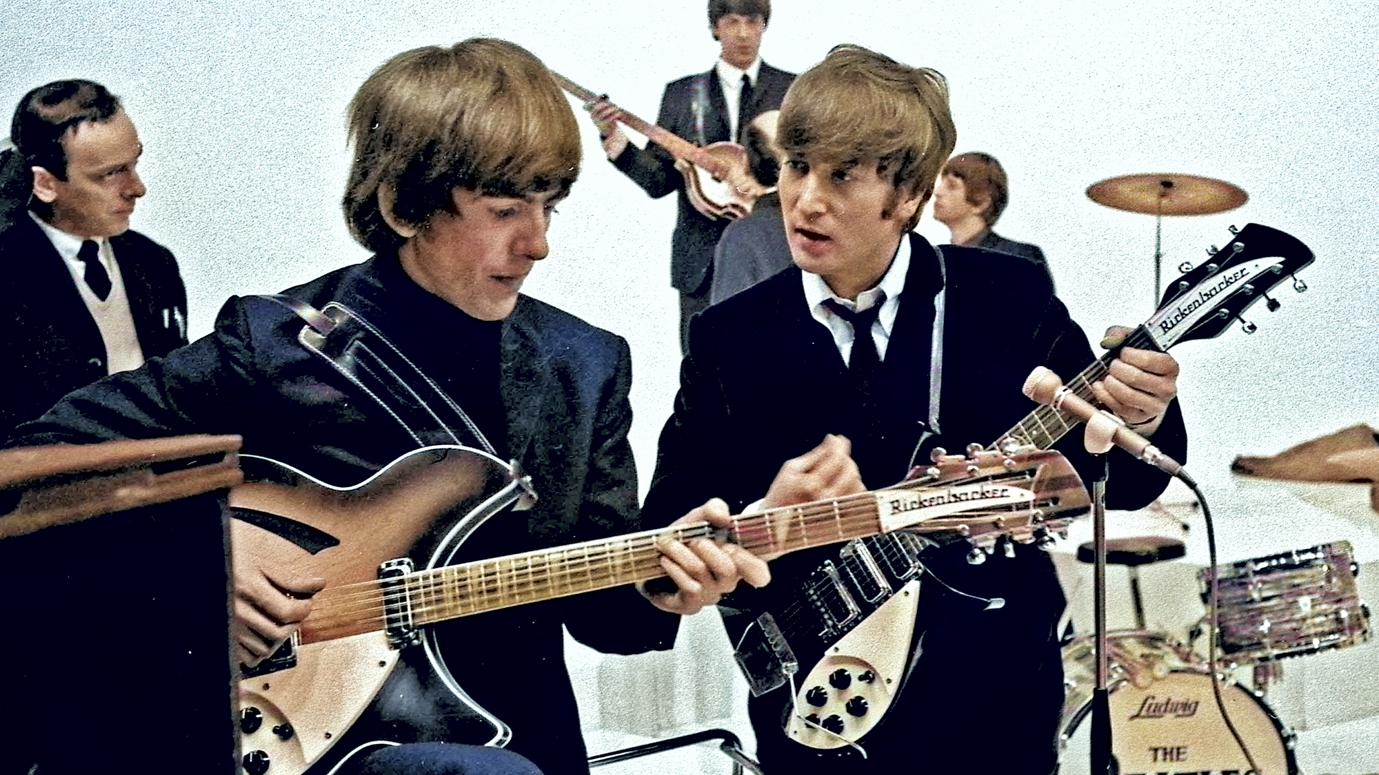 Photo of John LENNON and George HARRISON and BEATLES; L-R: John Junkin, George Harrison, Paul McCartney (background), John Lennon, Ringo Starr on set at the Scala Theatre during the filming of &quot;A Hard Day&#039;s Night&quot; 