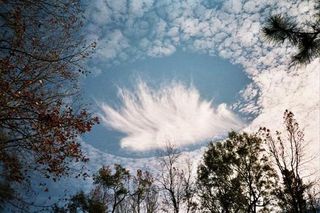 jet punches a hole in clouds