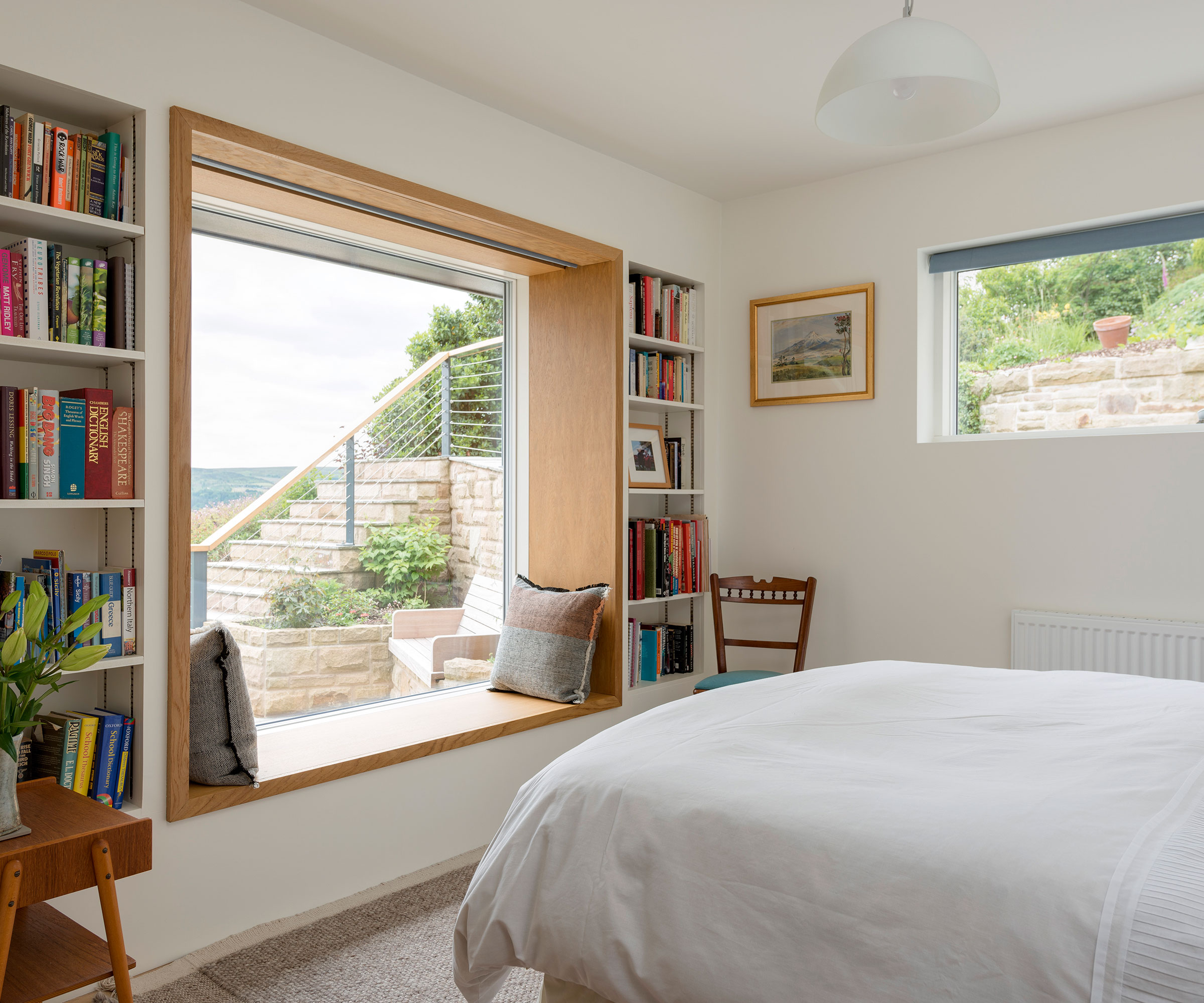 bedroom with window seat and high level window