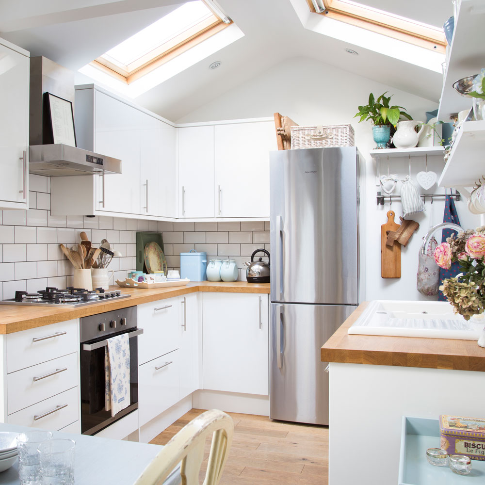 white kitchen with skylights and wooden worktops