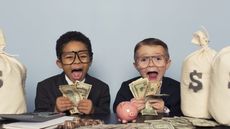Two children wearing suits and holding money